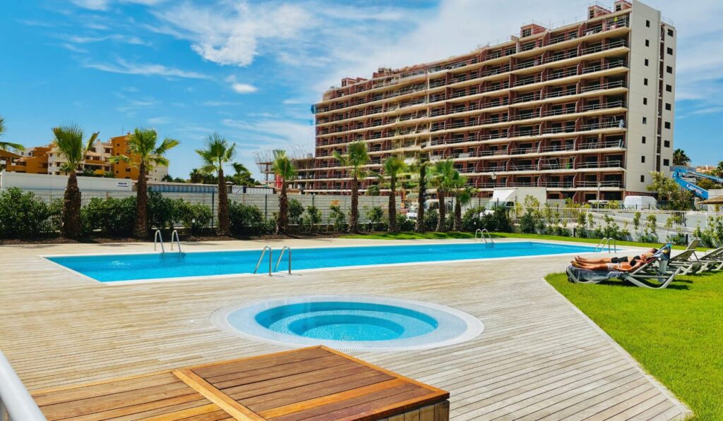 Brisa Azul Punta Prima — Community pool with jacuzzi and wooden sun deck