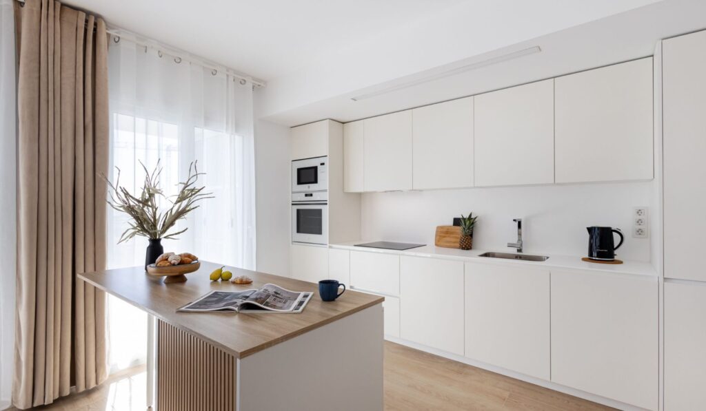 Panorama Valonia — Modern white kitchen with oven and microwave