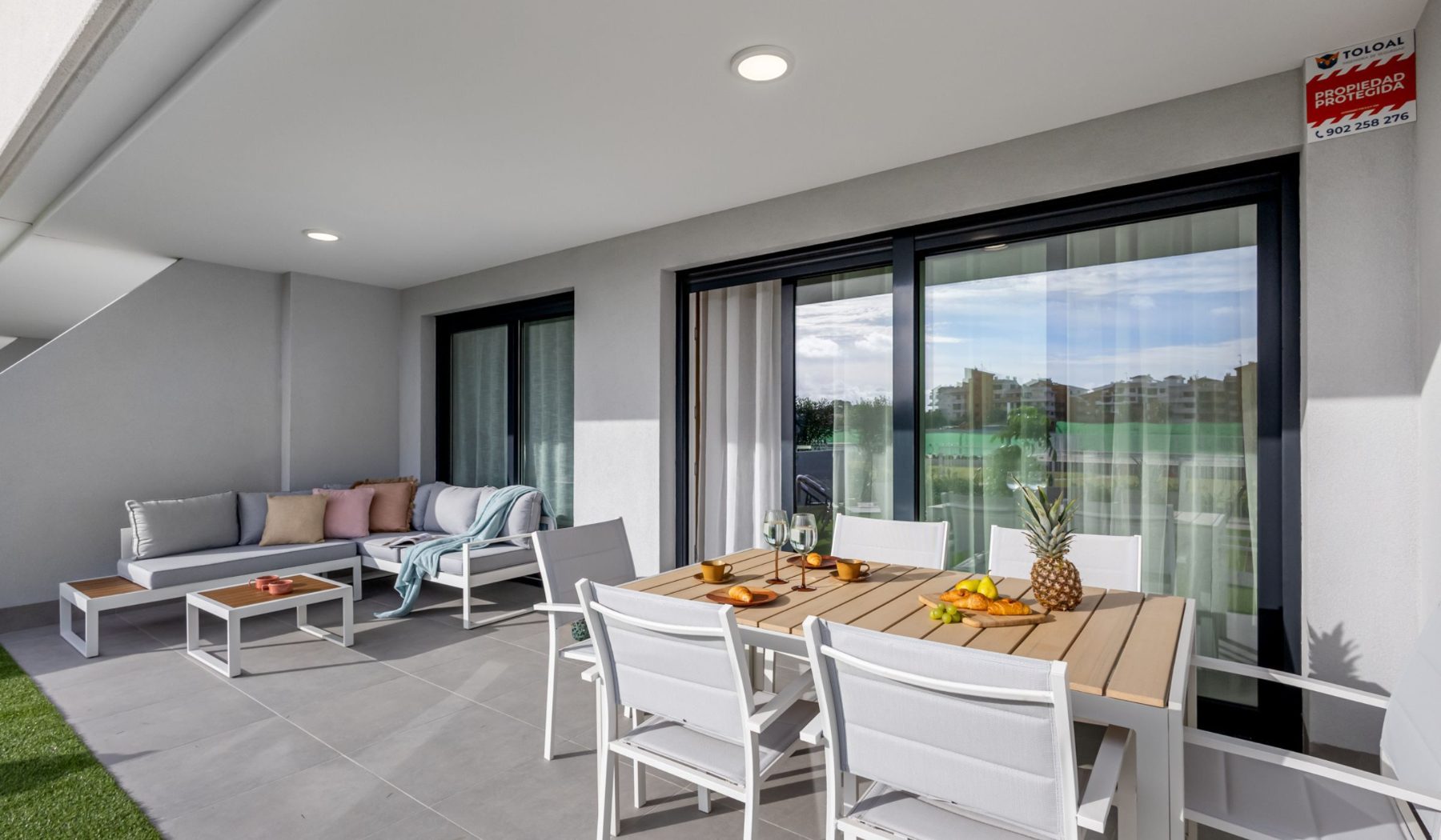 Sea Side Punta Prima — Ground-floor terrace with dining area and garden